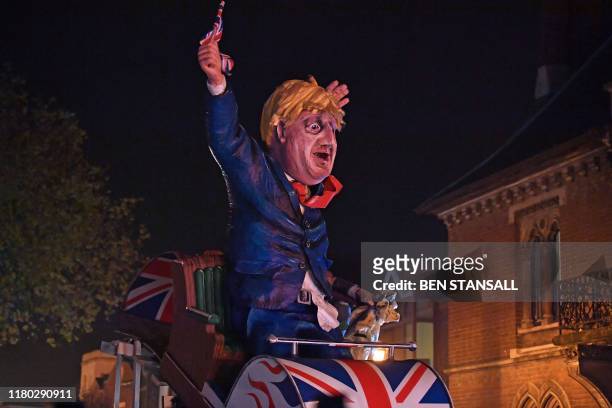 An effigy of Britain's Prime Minister Boris Johnson is paraded through the streets of Lewes in East Sussex, southern England, on November 5 during...