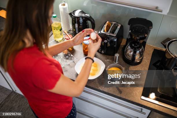 young woman preparing dinner - carton of eggs stock pictures, royalty-free photos & images