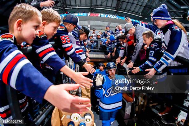 Bryan Little of the Winnipeg Jets heads to the ice for the pre-game warm up prior to NHL action against the New Jersey Devils at the Bell MTS Place...