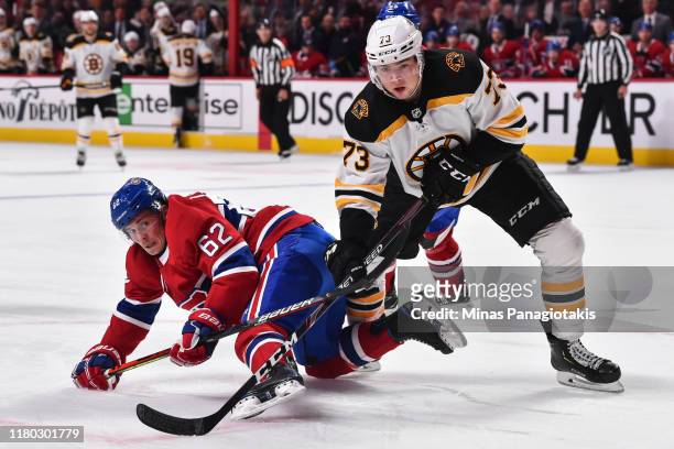Artturi Lehkonen of the Montreal Canadiens and Charlie McAvoy of the Boston Bruins battle for position during the third period at the Bell Centre on...
