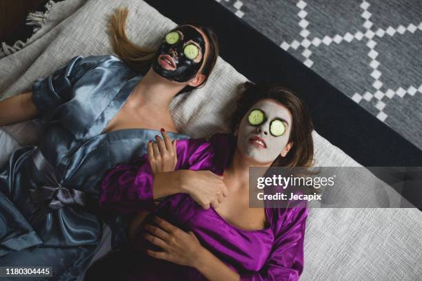 girls taking good care of their skin - silk robe stock pictures, royalty-free photos & images