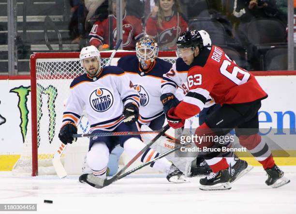 Kris Russell and Mikko Koskinen of the Edmonton Oilers defend against Jesper Bratt of the New Jersey Devils during the first period at the Prudential...