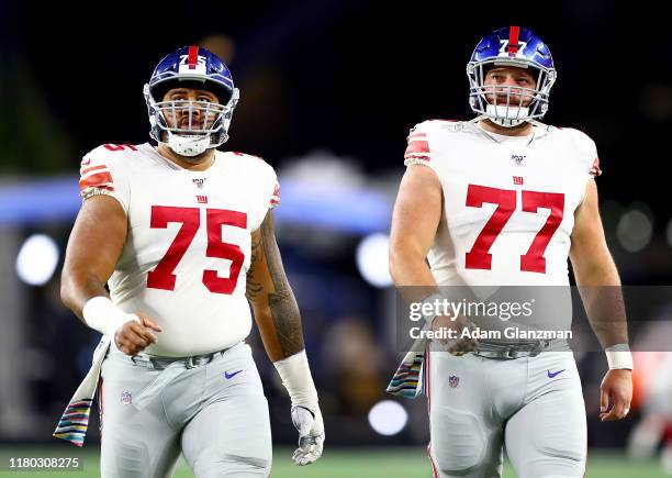 Jon Halapio and Spencer Pulley of the New York Giants look on prior to the game against the New England Patriots at Gillette Stadium on October 10,...