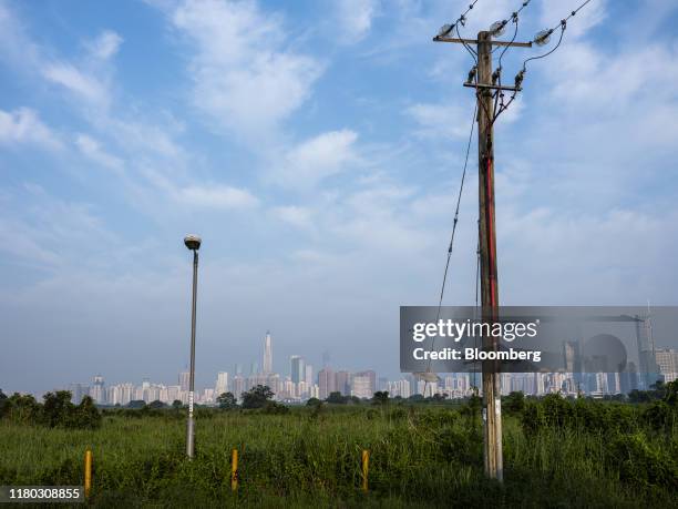 Buildings in Shenzhen stand on the horizon beyond farmland in the Ma Tso Lung district of Hong Kong, China, on Monday, Sept. 9, 2019. Hong Kong's...