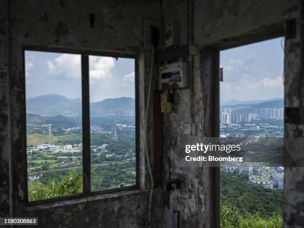 Farmland and buildings are seen from an abandoned building in the Lo Wu district of Hong Kong, China, on Monday, Sept. 9, 2019. Hong Kong's waning...