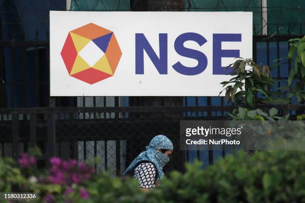 Woman walks past the logo of National Stock Exchange , outside its building in Mumbai, India on 05 November 2019.