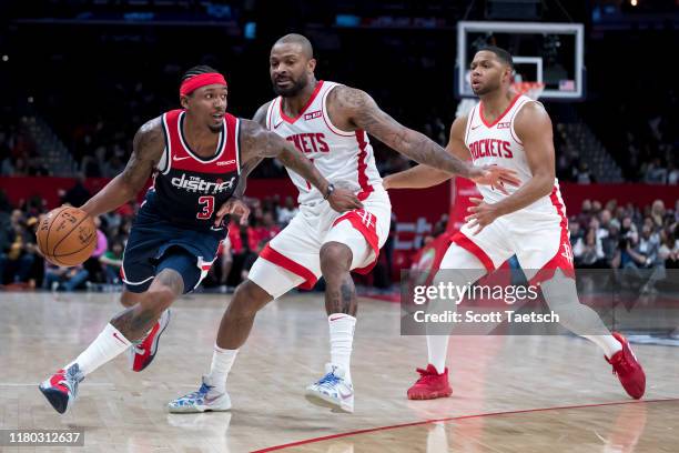 Bradley Beal of the Washington Wizards handles the ball against PJ Tucker and Eric Gordon of the Houston Rockets during the second half at Capital...