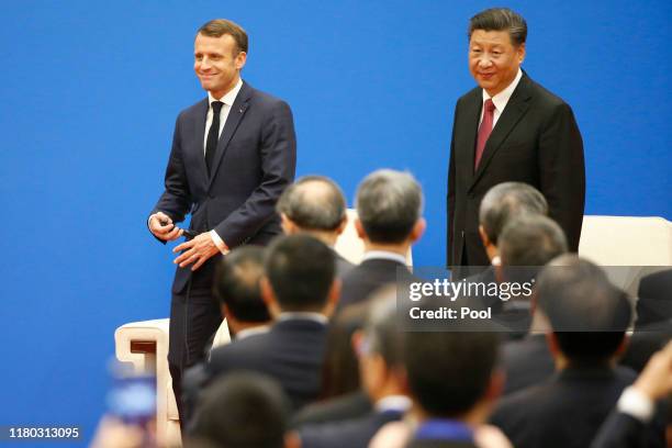 French President Emmanuel Macron and Chinese President Xi Jinping attend a China-France Economic Forum at the Great Hall of the People on November 6,...