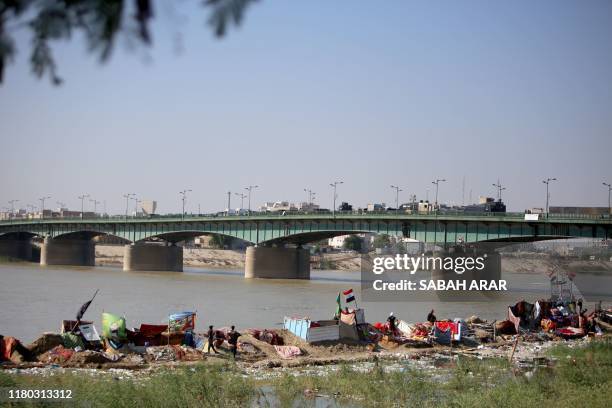 Iraqi protesters camp around Al-Jumhuriya Bridge on Baghdad's Tigris River on November 6 as the Iraqi capital braces for more anti-government...