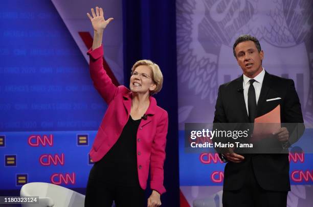 Democratic presidential candidate Sen. Elizabeth Warren , L, waves as CNN moderator Chris Cuomo looks on at the Human Rights Campaign Foundation and...