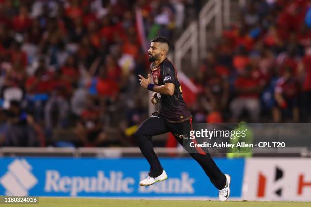 In this handout image provided by CPL T20, Ali Khan of Trinbago Knight Riders runs in to bowl during the Hero Caribbean Premier League match between...