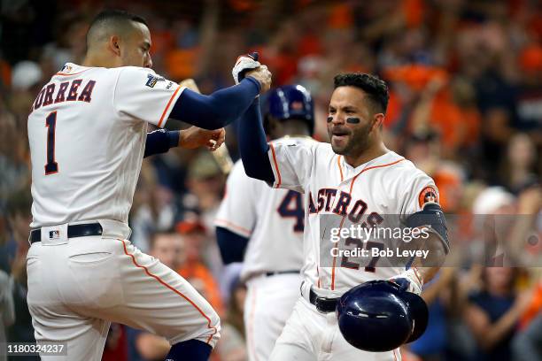 Jose Altuve of the Houston Astros is congratulated by his teammate Carlos Correa after his solo home run against the Tampa Bay Rays during the eighth...