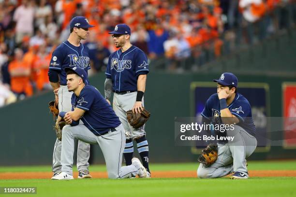 Joey Wendle, Willy Adames, Eric Sogard and Ji-Man Choi react against the Houston Astros during the eighth inningin game five of the American League...