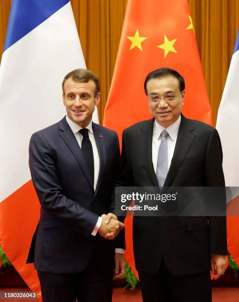 French President Emmanuel Macron shakes hands with Chinese Premier Li Keqiang before a meeting at The Great Hall Of The People on November 6, 2019 in...