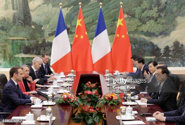 French President Emmanuel Macron and Chinese Premier Li Keqiang attend a meeting at The Great Hall Of The People on November 6, 2019 in Beijing,...