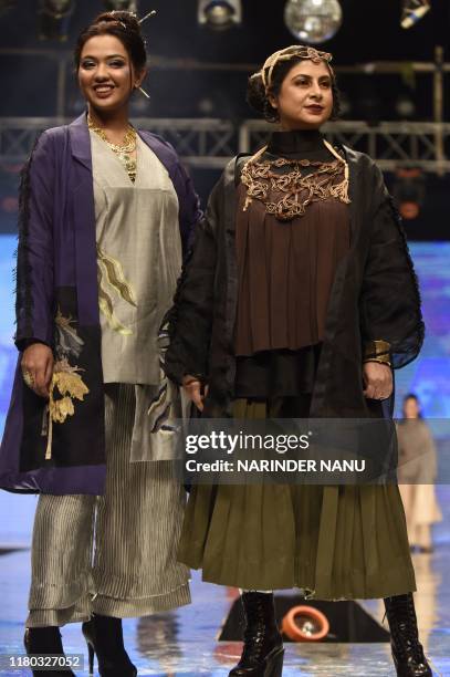 In this photo taken on November 5 members of Federation of Indian Chambers of Commerce and Industry Ladies Organization walk on a ramp during the...