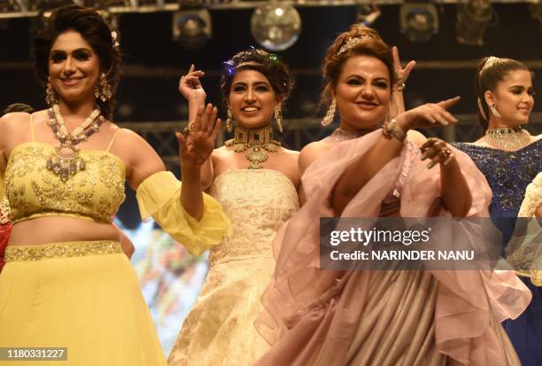 In this photo taken on November 5 members of Federation of Indian Chambers of Commerce and Industry Ladies Organization walk on a ramp during the...