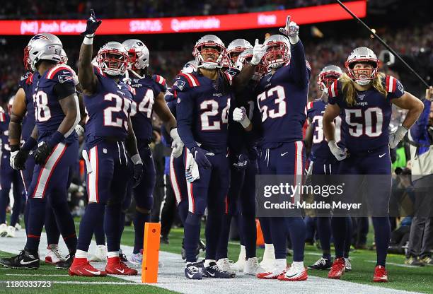 Kyle Van Noy of the New England Patriots celebrates with his teammates Terrence Brooks, Stephon Gilmore and Matthew Slater after recovering a fumble...