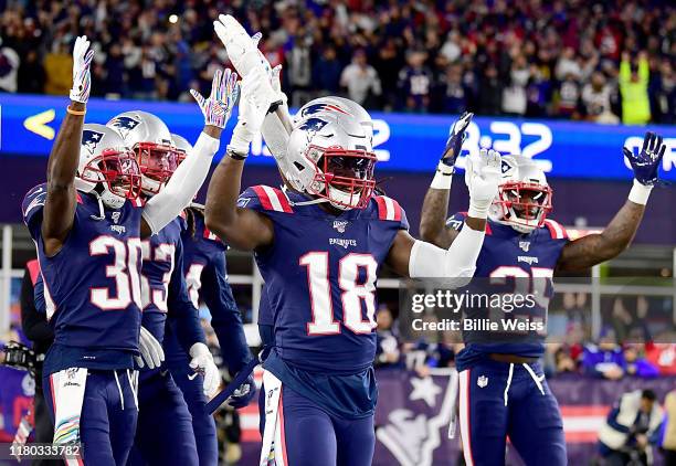 Kyle Van Noy of the New England Patriots celebrates with his teammates Jason McCourty, Matthew Slater and Terrence Brooks after recovering a fumble...