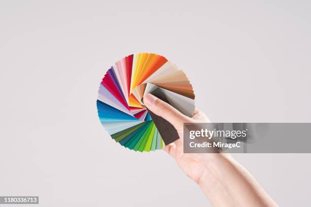 hand holding color swatches - muestra de colores fotografías e imágenes de stock