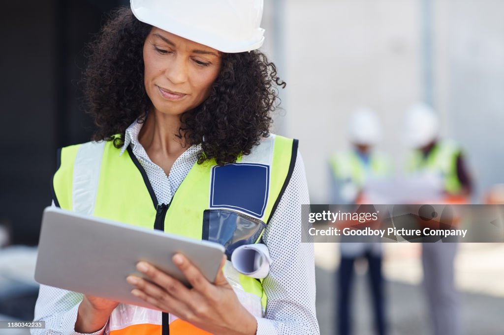 Female building engineer using a tablet on her work site