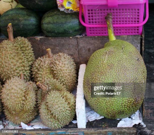 Fresh fruits on the shelves of a street vendor kiosk on a street in Thailand