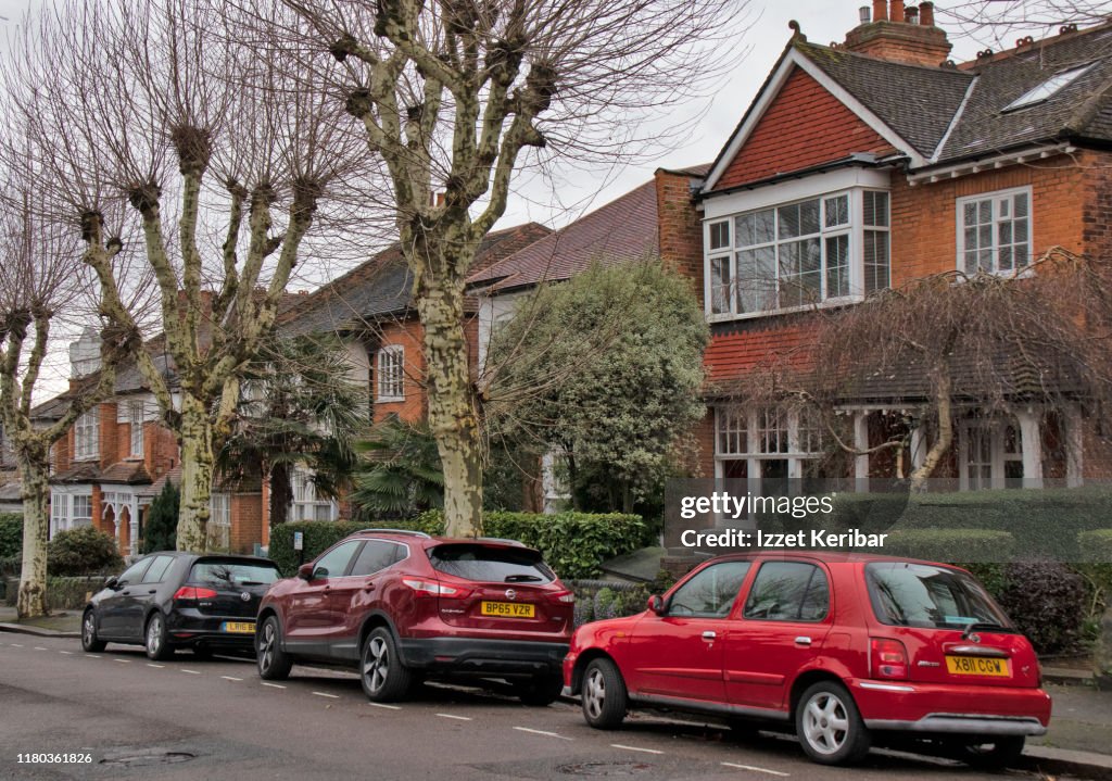 Car sparked in front of  typical houses north of London, UK