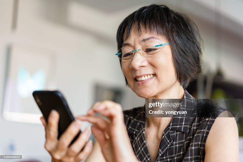 Senior Asian woman using a smartphone
