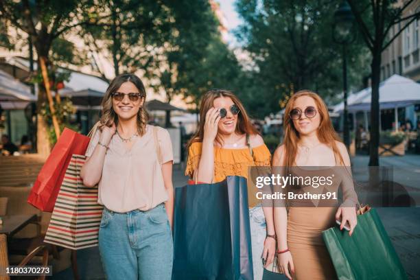 three girlfriends going shopping - girl after shopping stock pictures, royalty-free photos & images