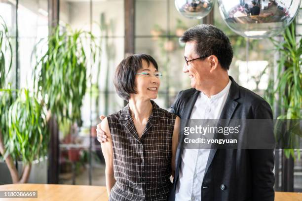 happy chinese couple at home - yongyuan hongkong stock pictures, royalty-free photos & images
