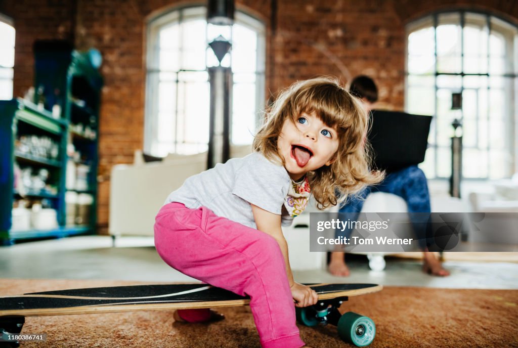Toddler Playing On Skateboard Indoors