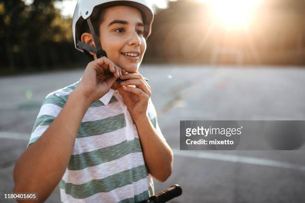 safety before fun - teenager cycling helmet stock pictures, royalty-free photos & images