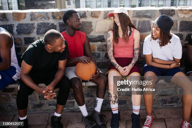 group of friends sit and chat - female basketball team stock pictures, royalty-free photos & images