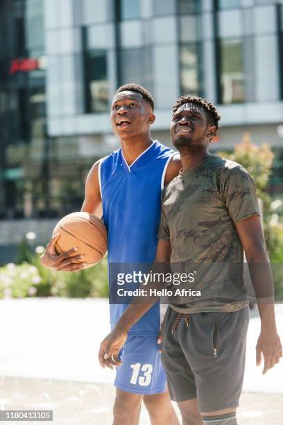 Handsome basketball players walking and looking at something in the air