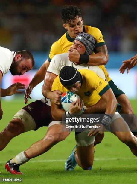 Matt Toomua grabs Beka Gorgadze o Georgia who in turn tackles Christian Lealiifano of Australia during the Rugby World Cup 2019 Group D game between...