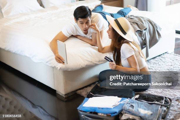 couple prepare luggage to travel - booking hotel stock pictures, royalty-free photos & images