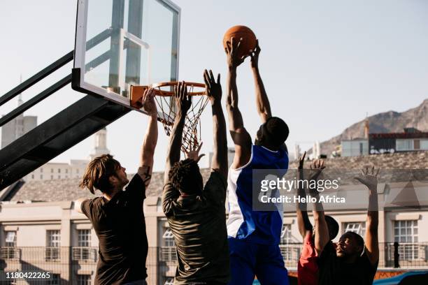 Basketball player jumping with ball in both hands and about to score a point