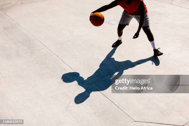 a basketball player and his shadow - shadow foto e immagini stock