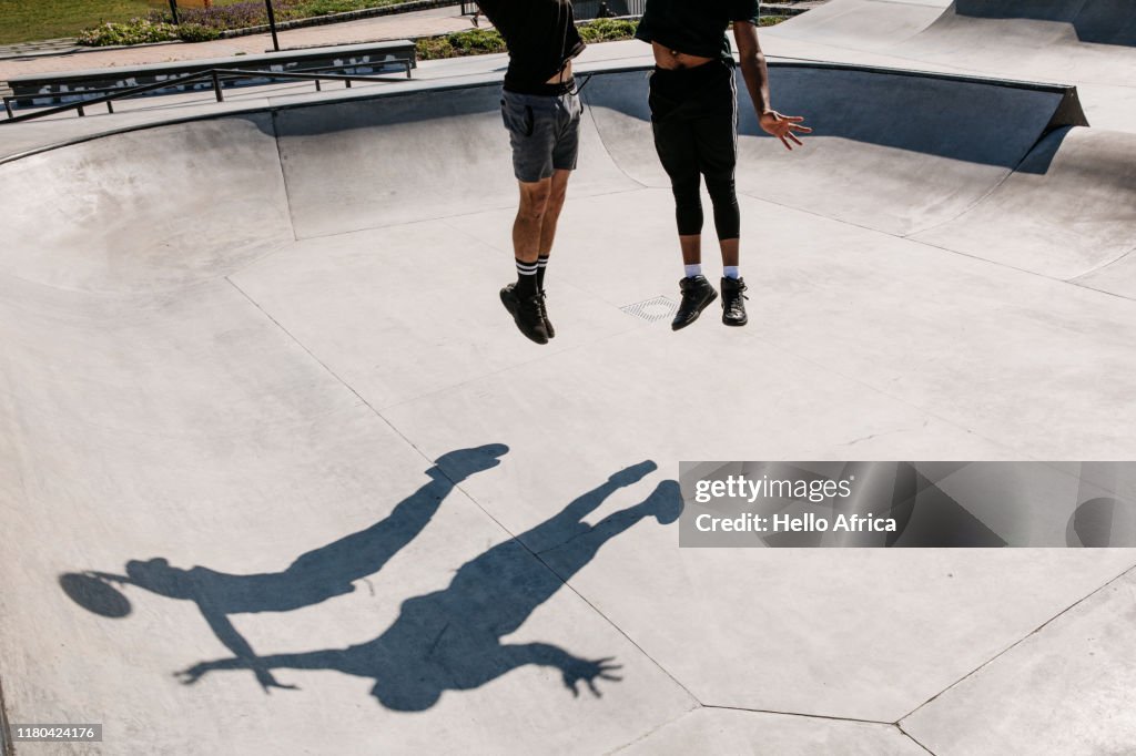 Players and their shadows jump for the ball