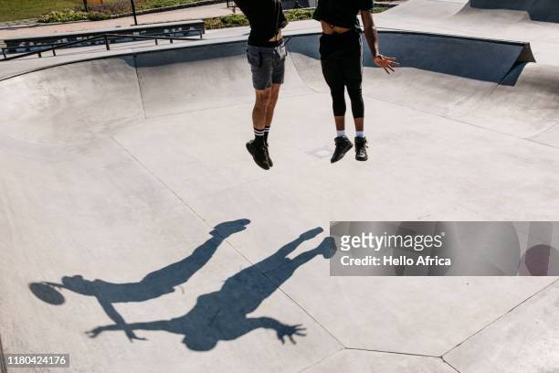 Players and their shadows jump for the ball