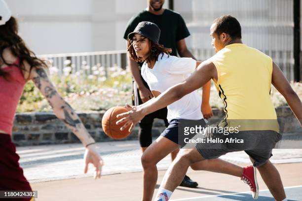 Young female basketball player running past an opponent intent on blocking her