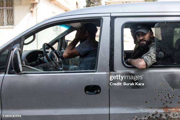 Members of the Turkish-backed Free Syrian Army, a militant group active in parts of northwest Syria, drive to the Turkey Syria border on October 11,...