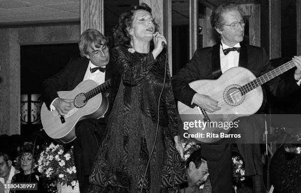Portuguese Fado singer Amalia Rodrigues performs on stage, Newark, New Jersey, November 28, 1987. The guitarists performing with her are unidentified.