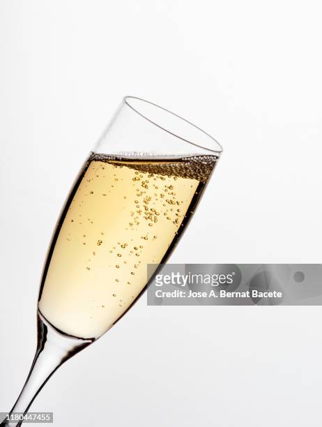 a glass of champagne on a white background. - champagner gläser mit flasche unscharfer hintergrund stock-fotos und bilder
