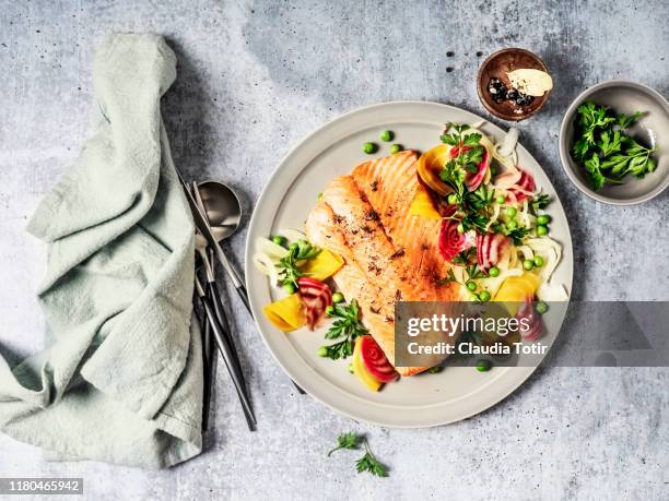 pan fried salmon with vegetables on gray background - 俯瞰　料理 ストックフォトと画像