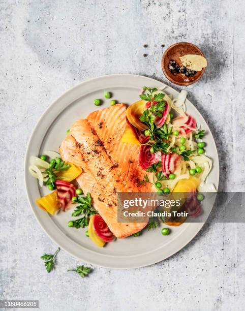 pan fried salmon with vegetables on gray background - cooking fish stock pictures, royalty-free photos & images