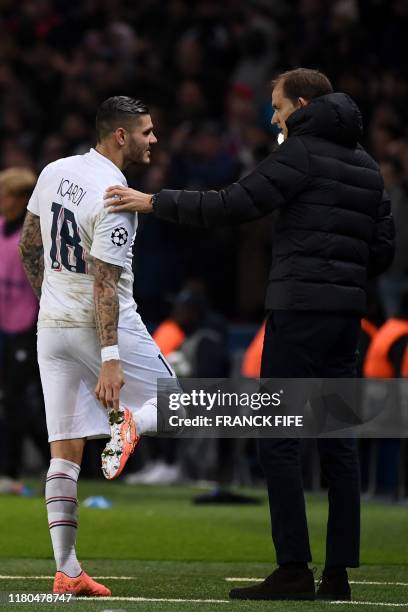 Paris Saint-Germain's Argentine forward Mauro Icardi talks with Paris Saint-Germain's German coach Thomas Tuchel as he leaves the pitch during the...