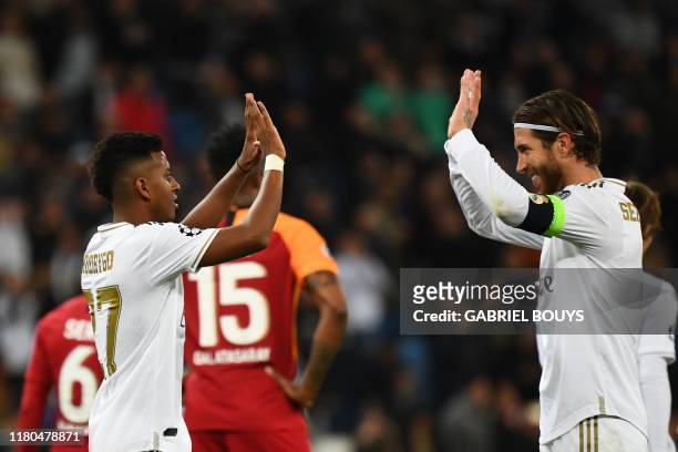 Real Madrid's Brazilian forward Rodrygo celebrates with Real Madrid's Spanish defender Sergio Ramos after scoring during the UEFA Champions League...