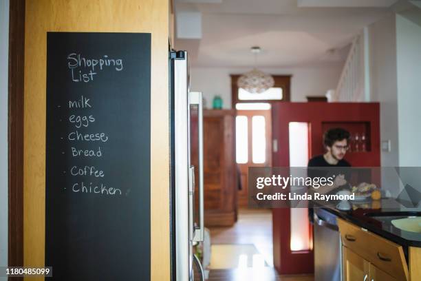 shopping list - young man groceries kitchen stock pictures, royalty-free photos & images