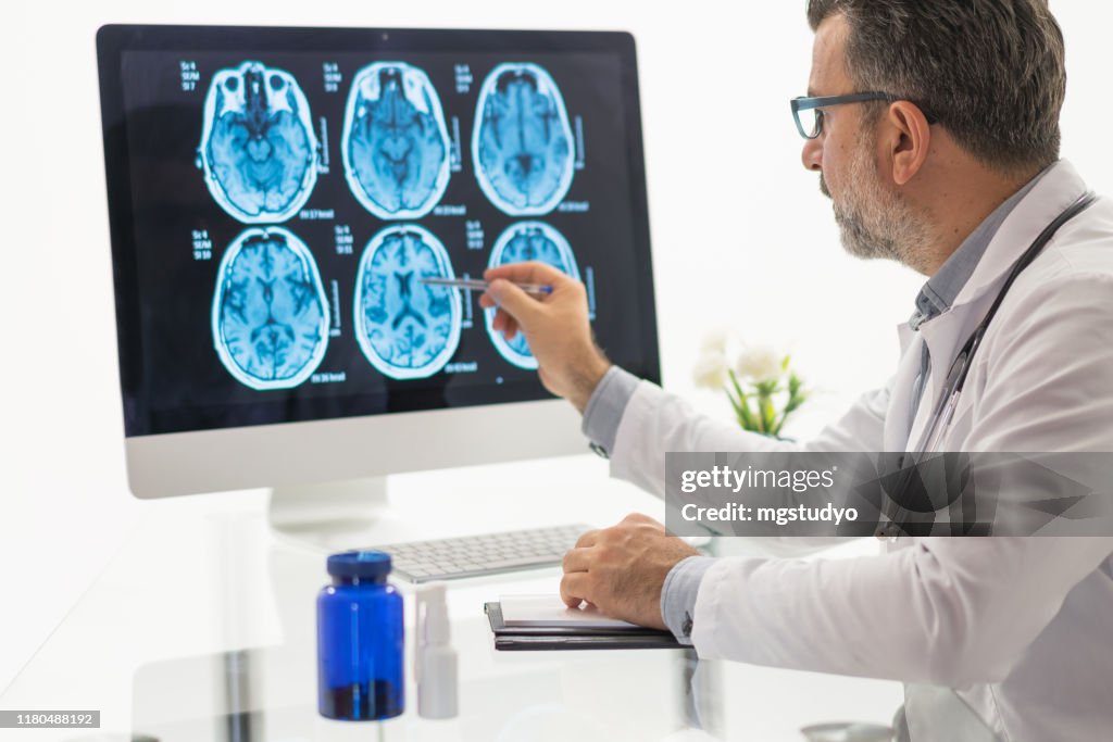 Males doctor examining brain MR